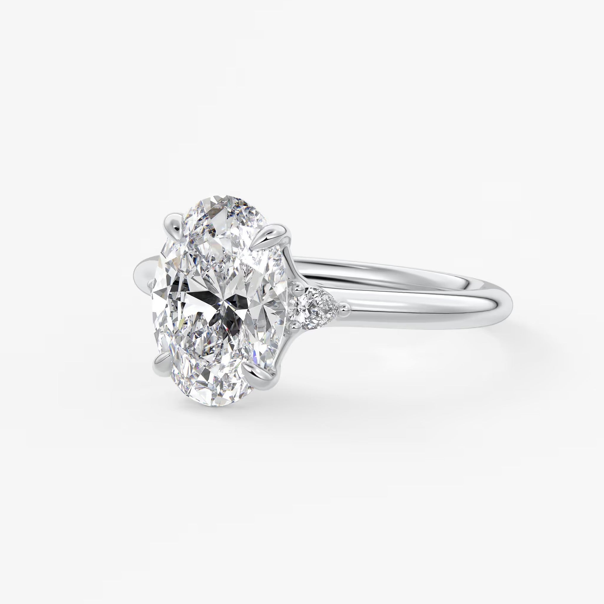 Cassia – oval trilogy with pear side stones
