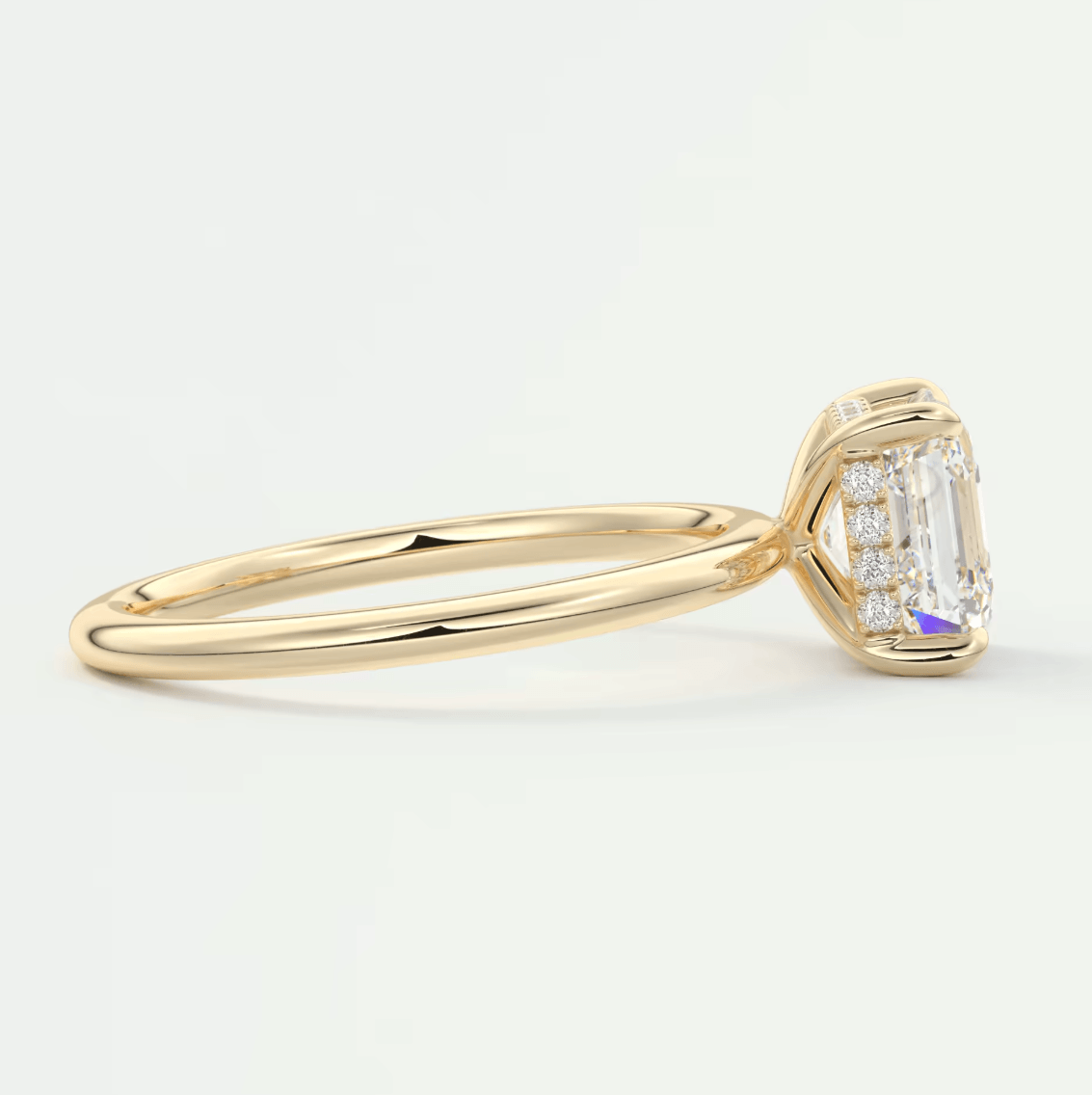 18k yellow gold emerald-cut diamond engagement ring.