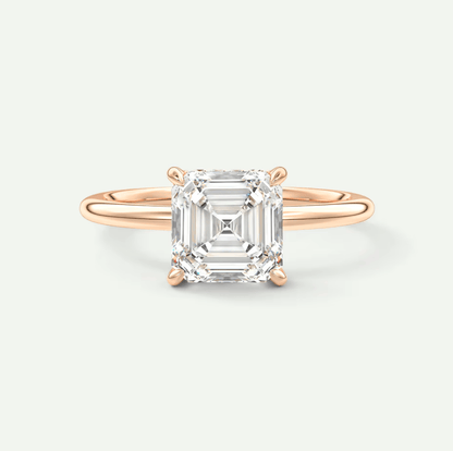 18-karat rose gold engagement ring with a cushion-cut diamond.