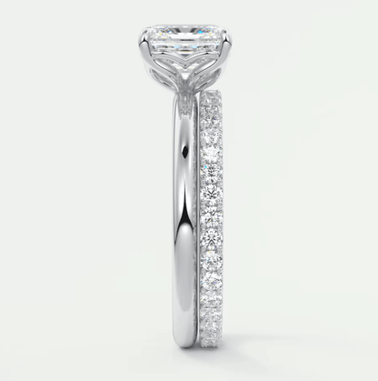 18k white gold engagement ring with a princess cut diamond and pavé set diamonds on the band.