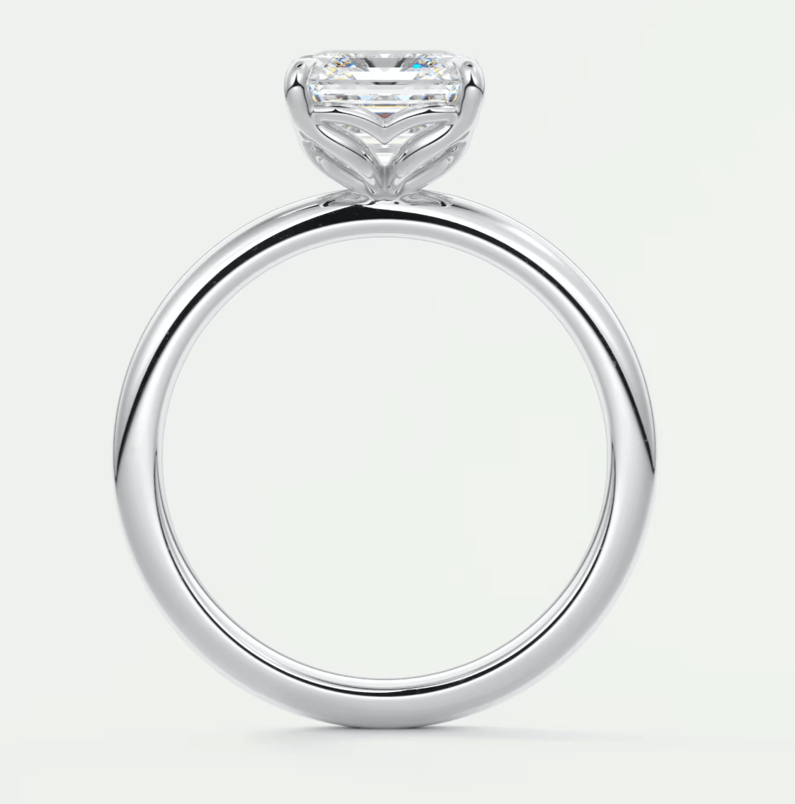18-karat white gold solitaire engagement ring with a princess-cut diamond.