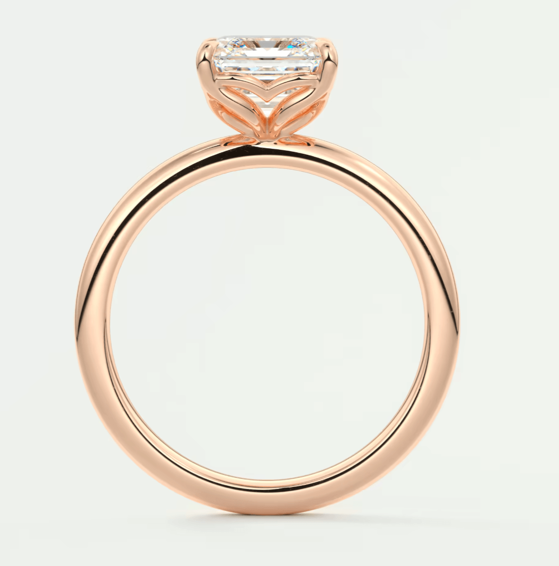 18-karat rose gold engagement ring with a princess-cut diamond.