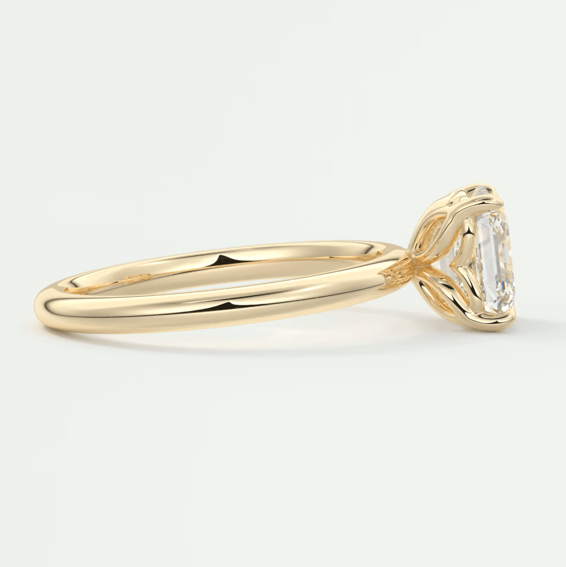 18k yellow gold engagement ring with an emerald-cut diamond.
