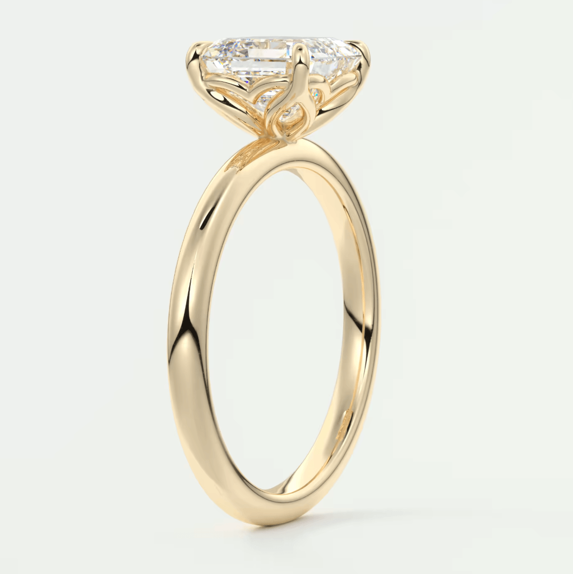 18k yellow gold engagement ring with a cushion-cut diamond.