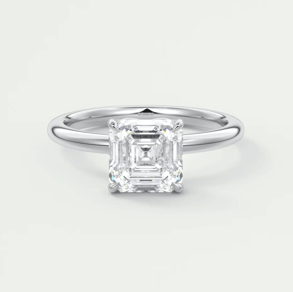 18-karat white gold emerald-cut diamond engagement ring.