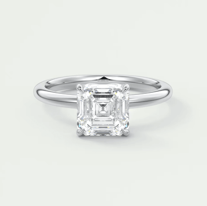 18-karat white gold emerald-cut diamond engagement ring.