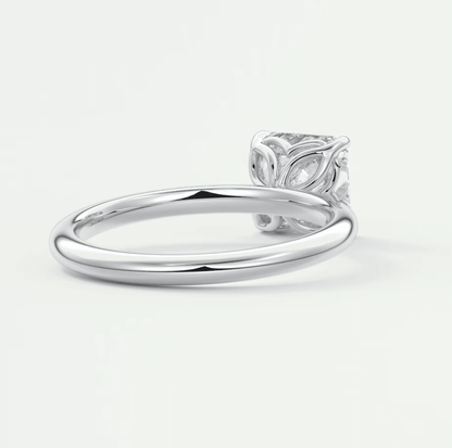 White diamond engagement ring with leaf design on band, platinum or silver material.