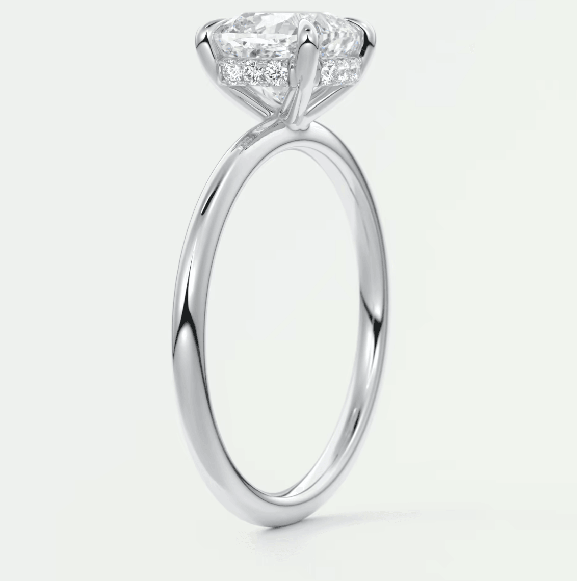 18-karat white gold engagement ring with a princess-cut diamond and pave-set diamonds on the band.