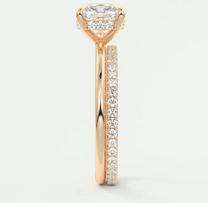 18k rose gold engagement ring with princess cut diamond and pave set diamonds on band.