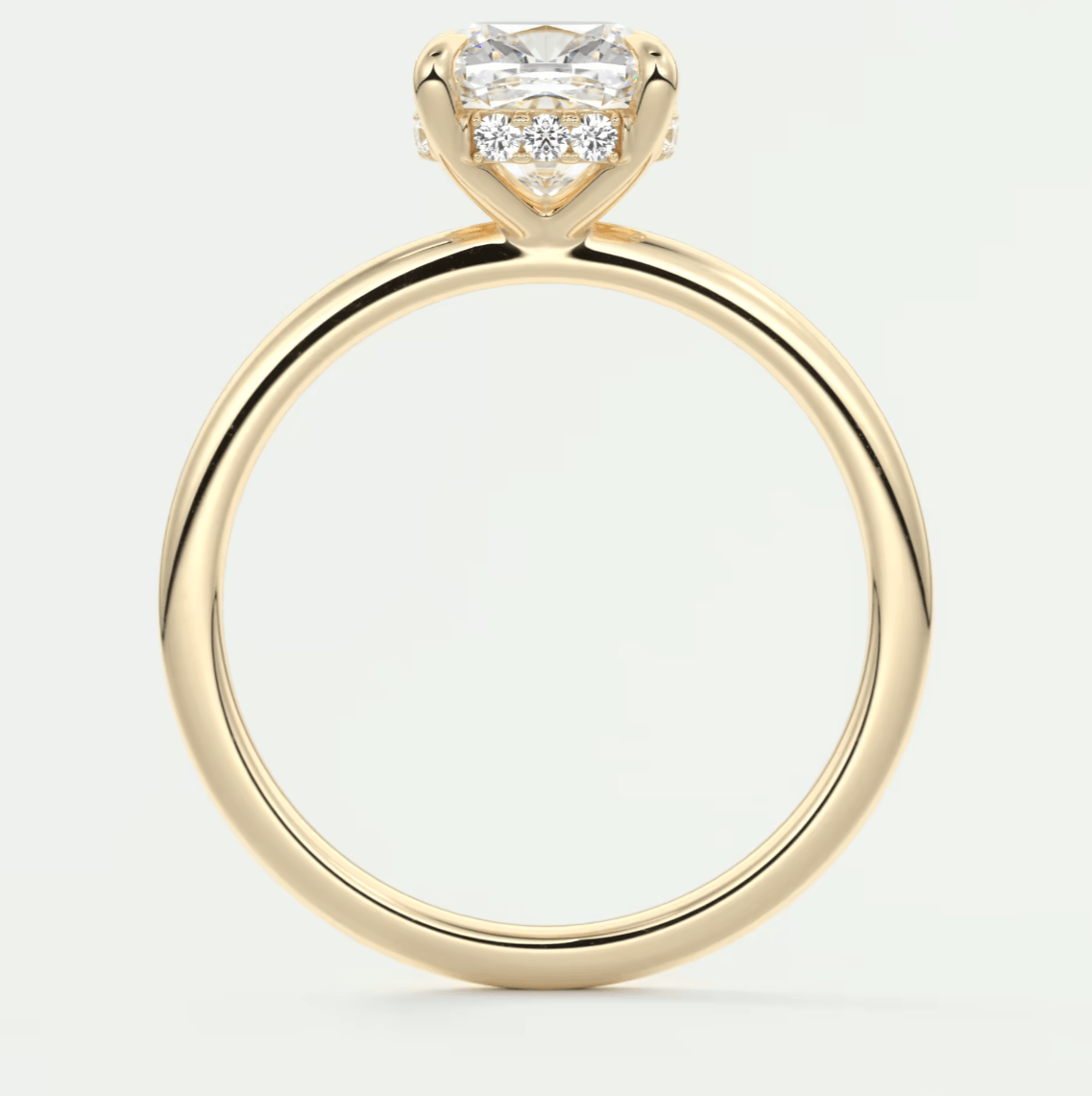 18-karat yellow gold engagement ring with a princess-cut diamond center stone and small diamonds on the band.