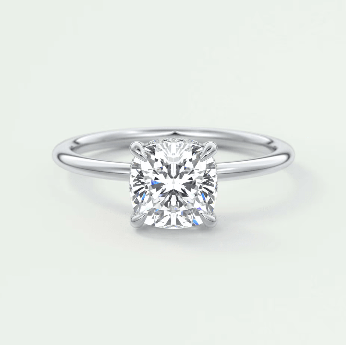 Cushion-cut diamond engagement ring with a white gold band.