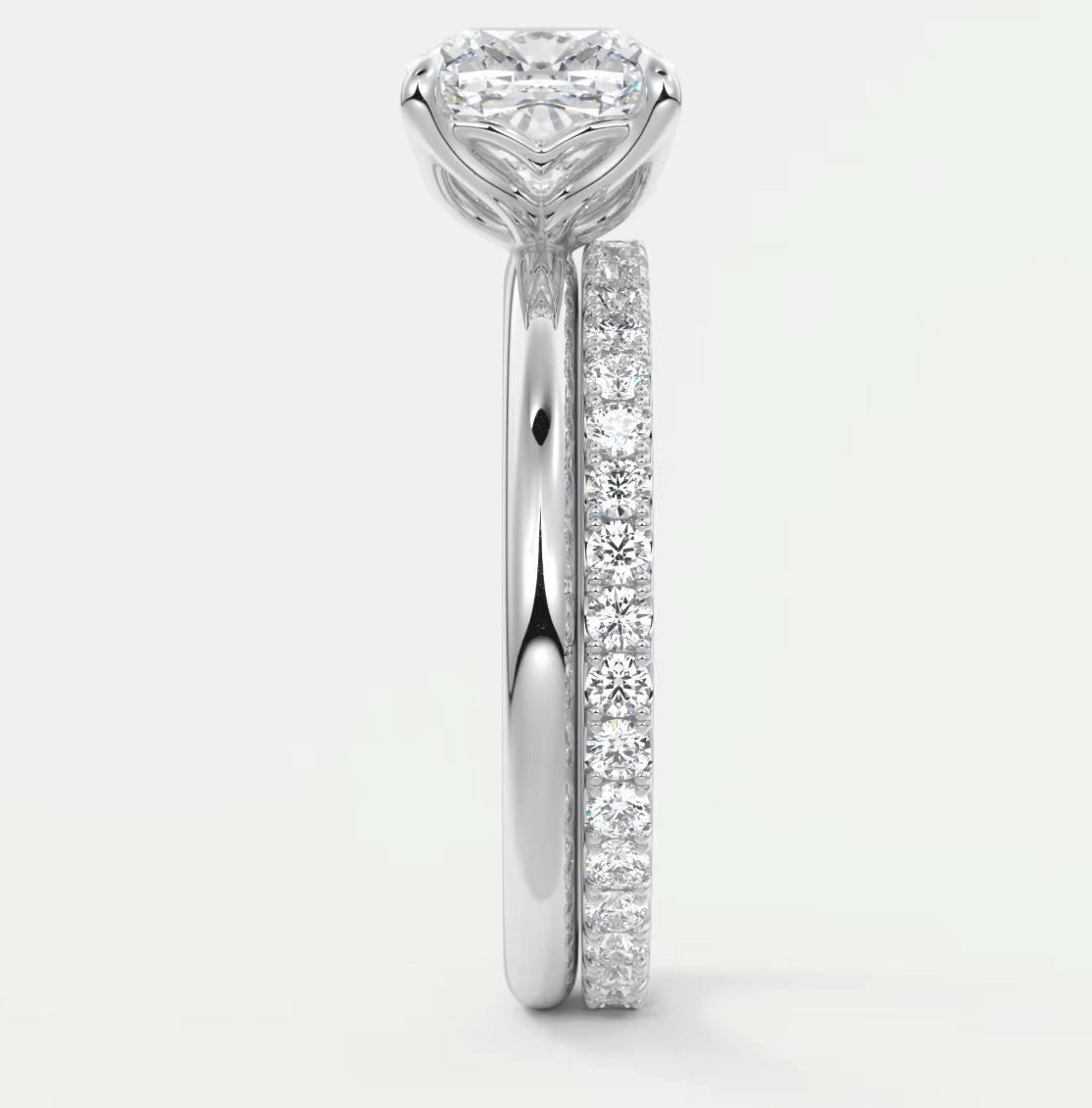 18k white gold diamond engagement ring with a princess cut center stone and channel set diamonds on the band.