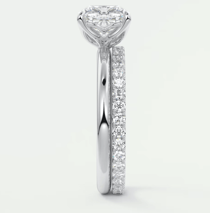 18k white gold diamond engagement ring with a princess cut center stone and channel set diamonds on the band.