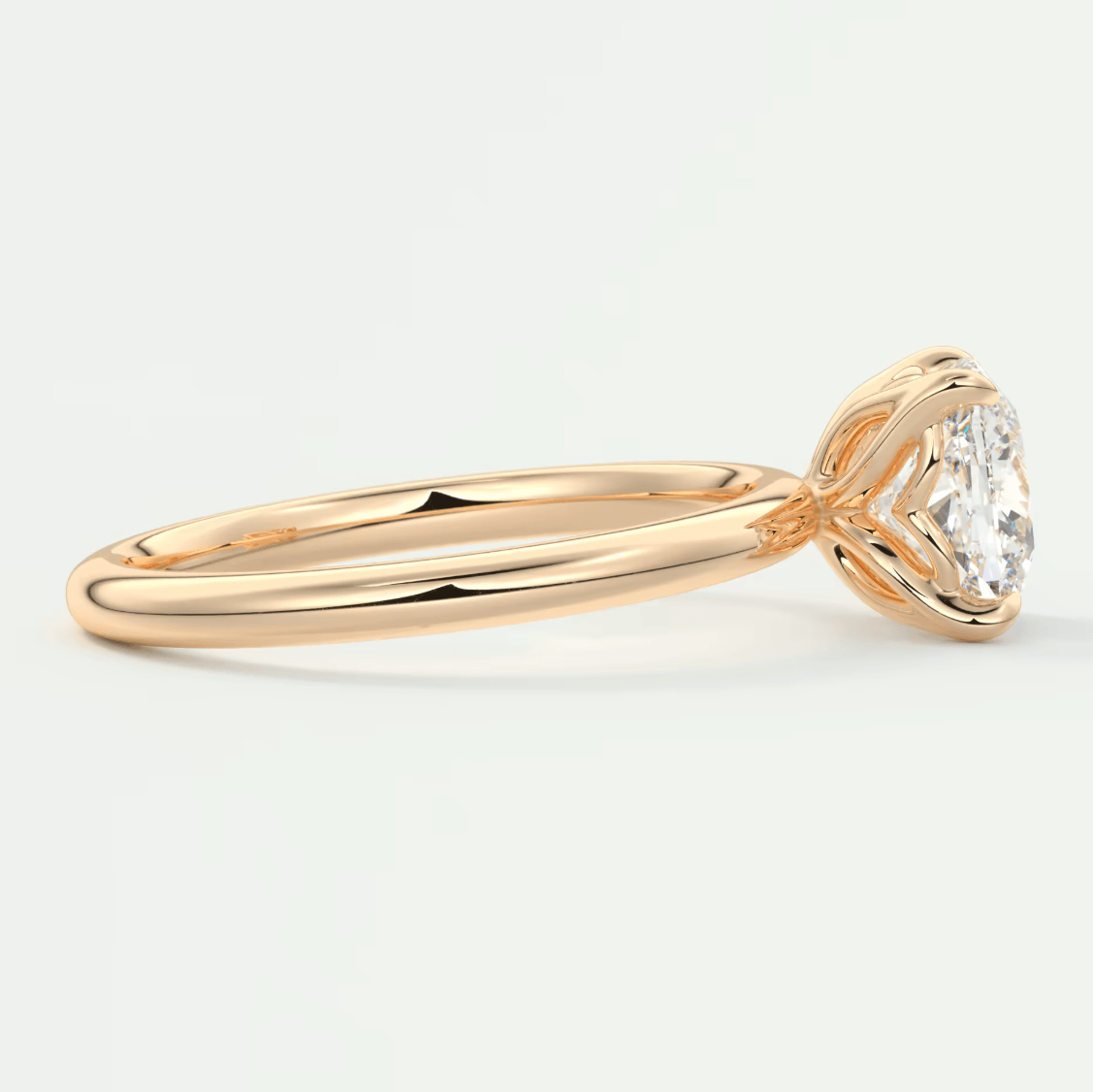 18k rose gold diamond engagement ring with a solitaire design.