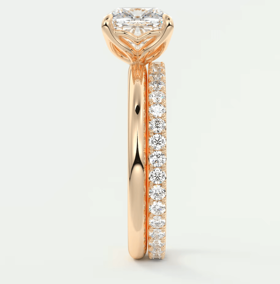 18k rose gold diamond engagement ring with a princess cut center stone and channel set diamonds on the band.
