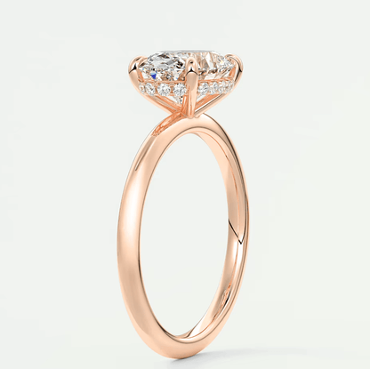 18k rose gold engagement ring with a princess cut diamond.