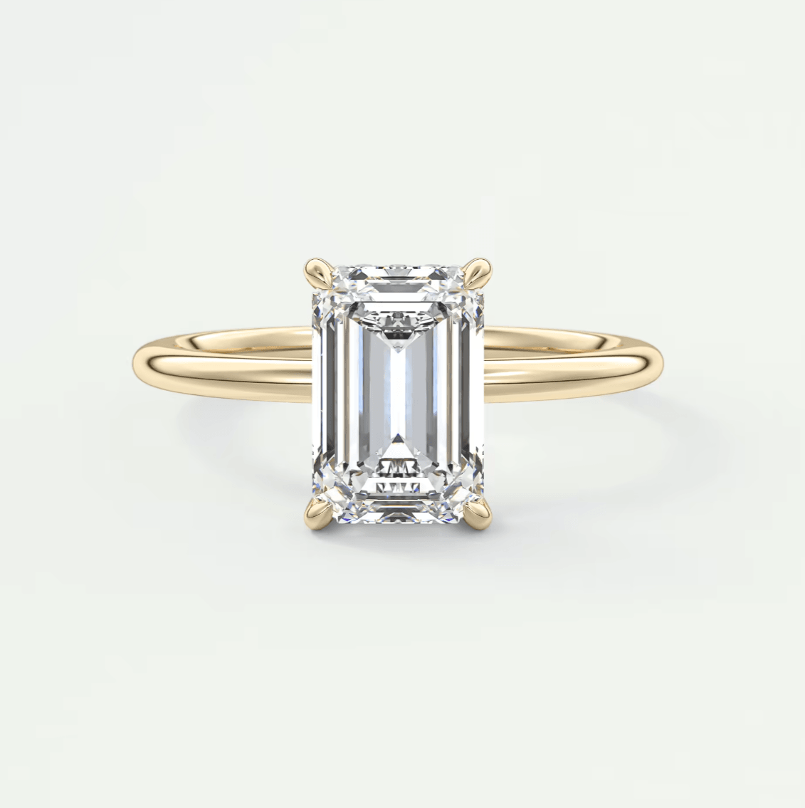 18k yellow gold emerald-cut diamond engagement ring.