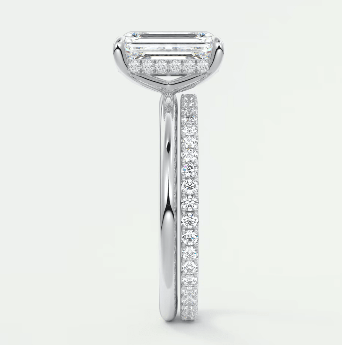 18-karat white gold engagement ring with a rectangular diamond center and pavé diamonds on the band.