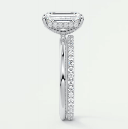 18-karat white gold engagement ring with a rectangular diamond center and pavé diamonds on the band.