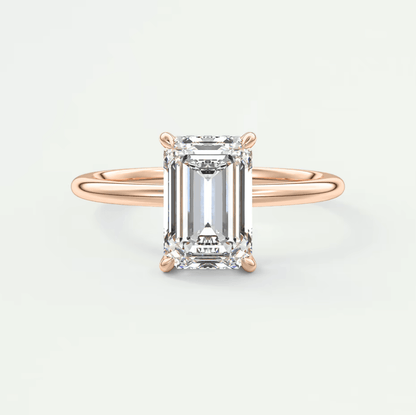 18k rose gold emerald-cut diamond engagement ring with a white diamond accent.