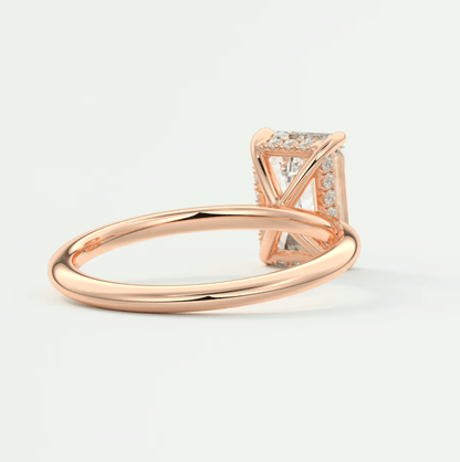 Rose gold diamond engagement ring with a princess cut center stone and smaller diamonds on the band.