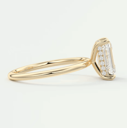 18k yellow gold diamond engagement ring with emerald-cut center stone and baguette side stones.