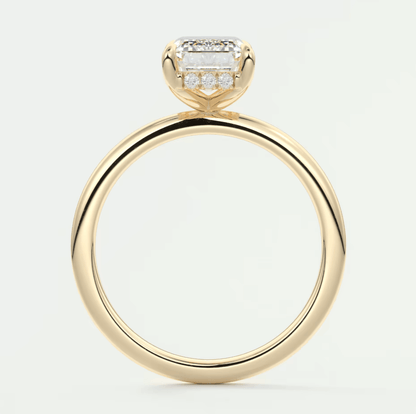 18k yellow gold engagement ring with a princess cut diamond and pave set diamonds on the band.