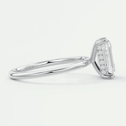 18k white gold emerald cut diamond engagement ring with a halo of smaller diamonds.