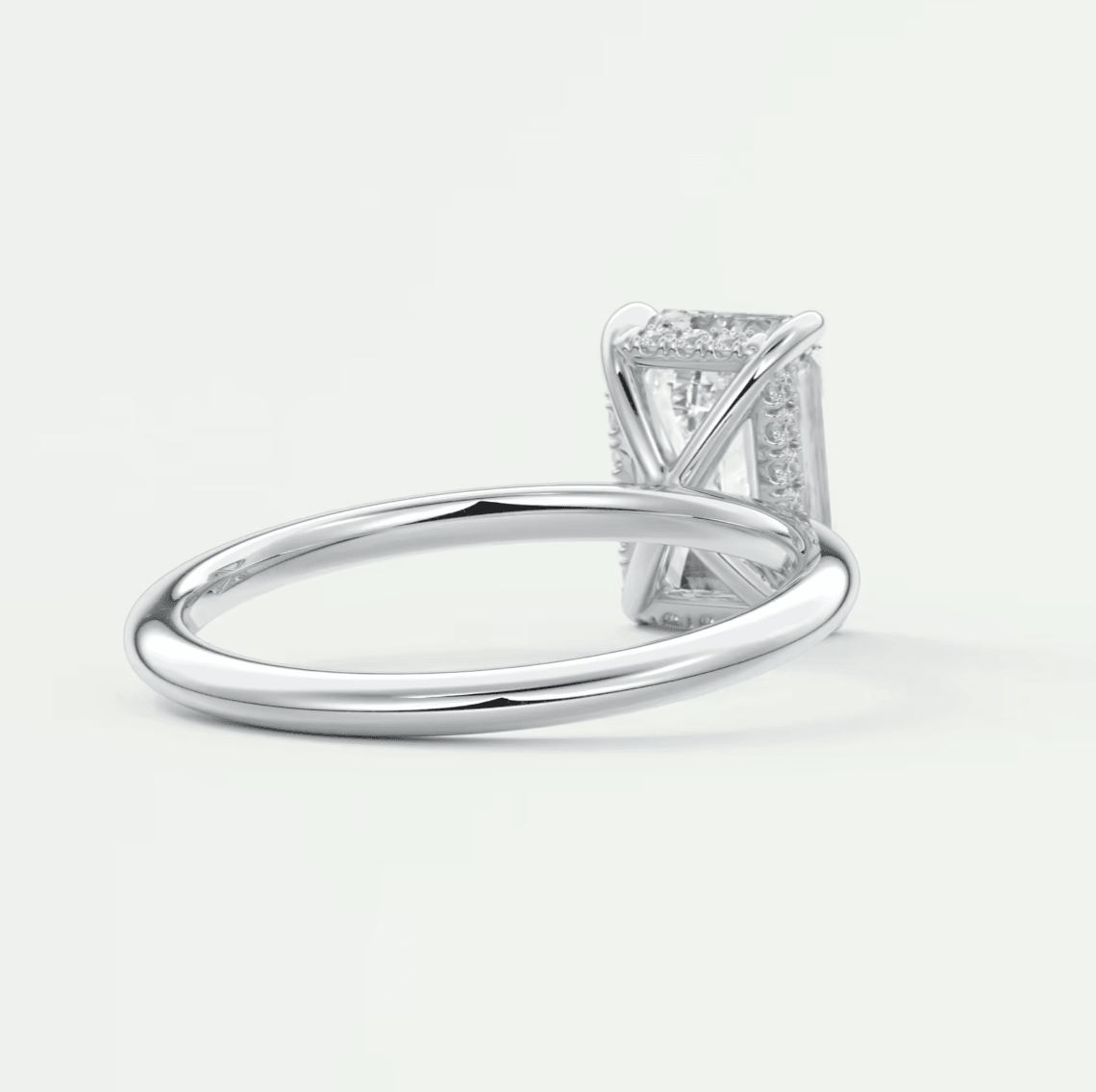White gold diamond engagement ring with a princess cut center stone and pave set diamonds on the band.