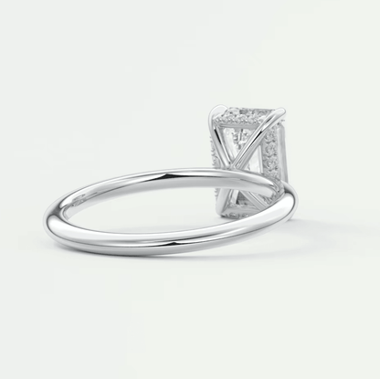 White gold diamond engagement ring with a princess cut center stone and pave set diamonds on the band.