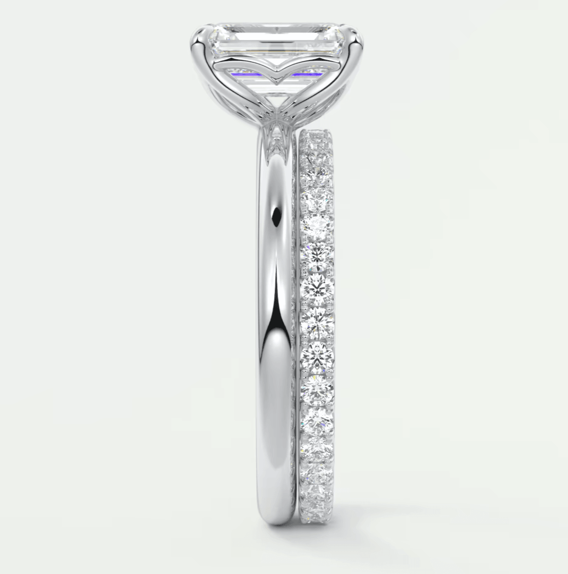 White diamond engagement ring with a marquise-cut center stone and pave set diamonds on the band.