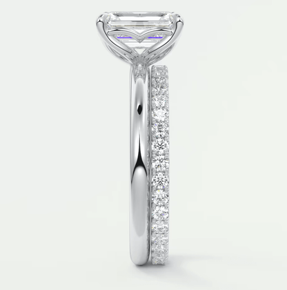 White diamond engagement ring with a marquise-cut center stone and pave set diamonds on the band.