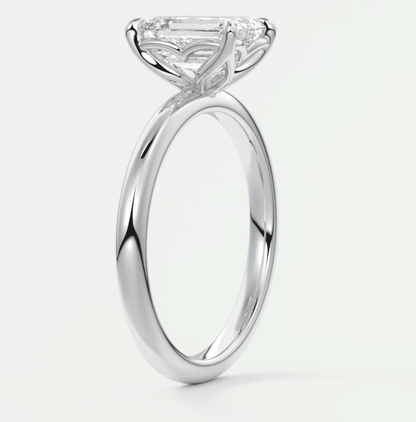 18-karat white gold engagement ring with a marquise-cut diamond.