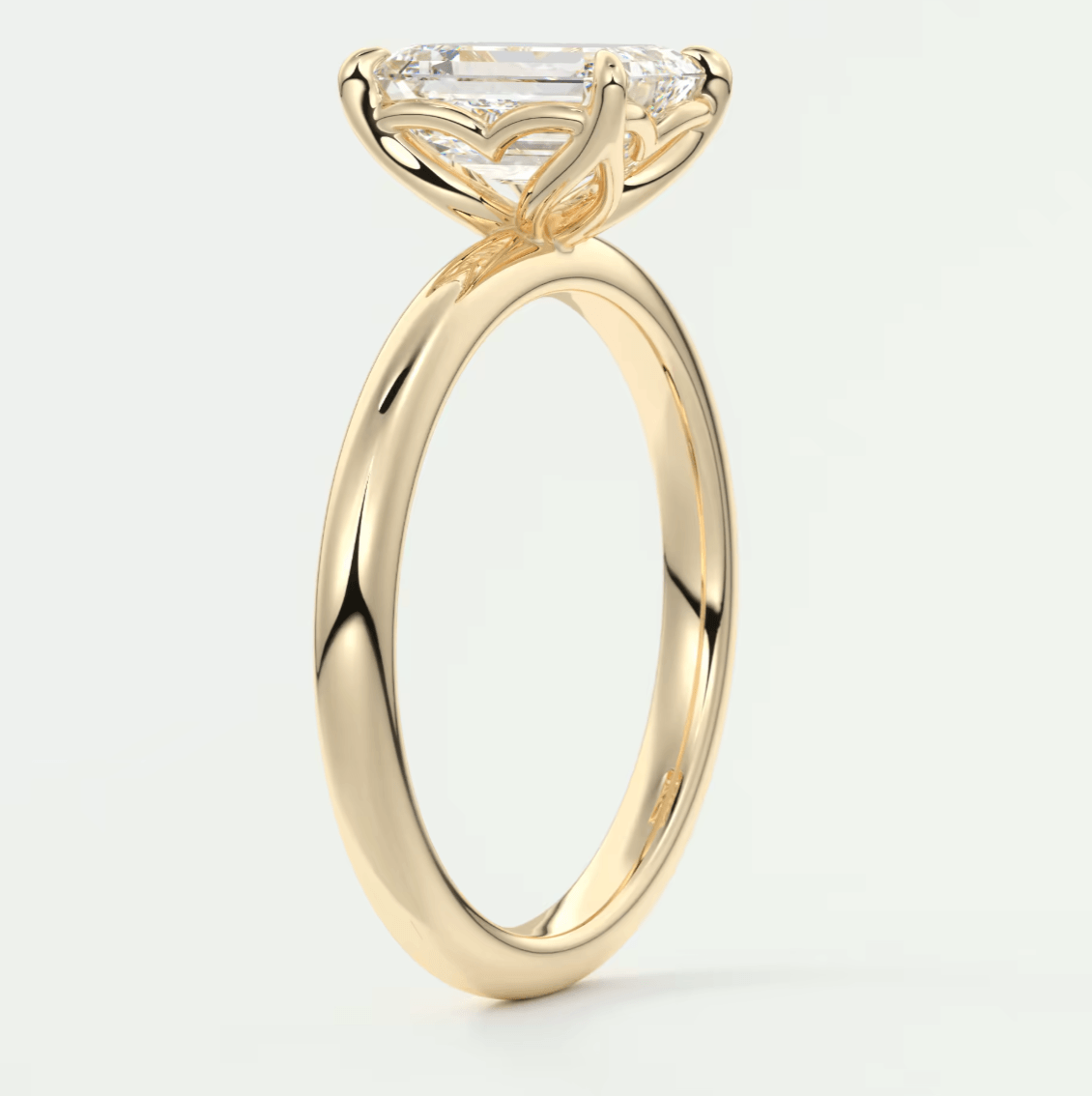 18-karat yellow gold engagement ring with a marquise-cut diamond and small diamonds on the band.