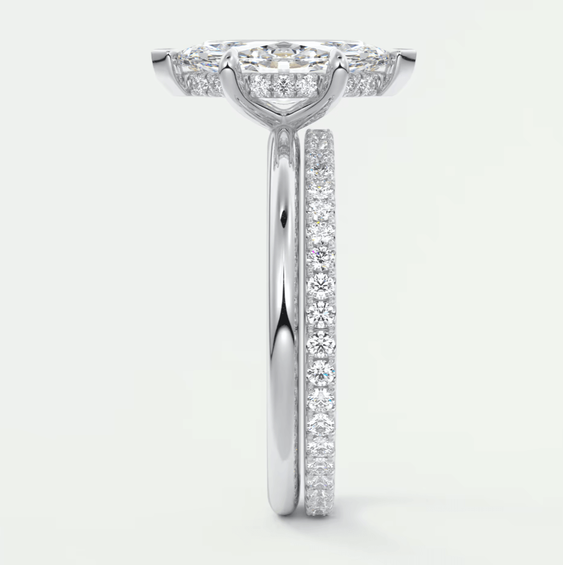 18-karat white gold diamond engagement ring with a halo setting and pavé band.