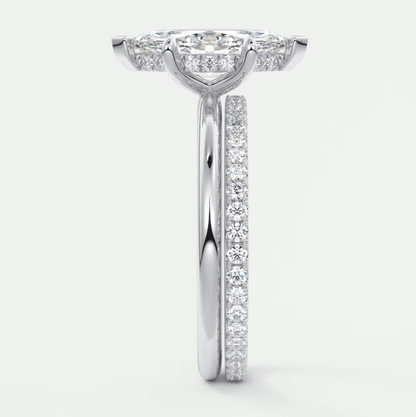 18-karat white gold diamond engagement ring with a halo setting and pavé band.