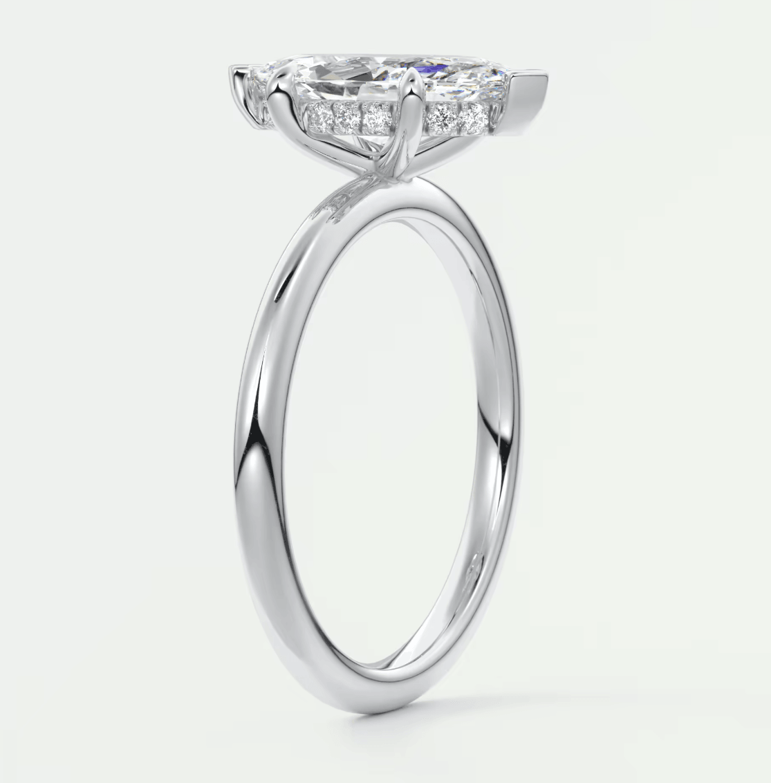 18k white gold engagement ring with a princess cut diamond and small diamonds on the band.