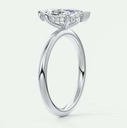 18k white gold engagement ring with a princess cut diamond and small diamonds on the band.
