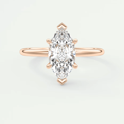 Rose gold marquise diamond engagement ring with a single stone setting and delicate band design.