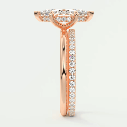 18-karat rose gold diamond engagement ring with a halo design.