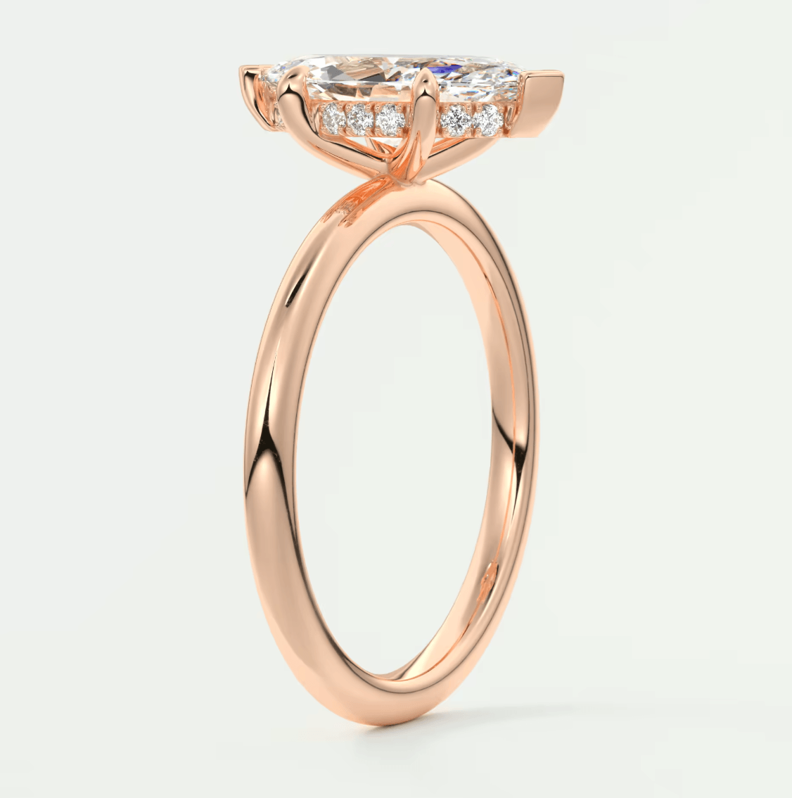 18-karat rose gold engagement ring with a princess-cut diamond and small diamonds on the band.