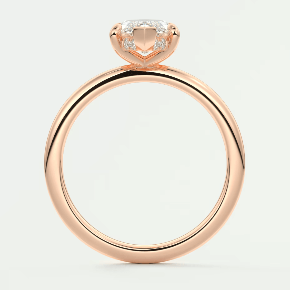 Rose gold engagement ring with a cushion-cut diamond and small side diamonds, featuring an elegant solitaire design.