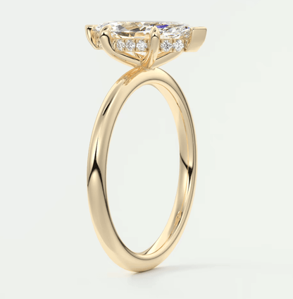 18-karat yellow gold engagement ring with a cushion-cut diamond and smaller diamonds set in the band.