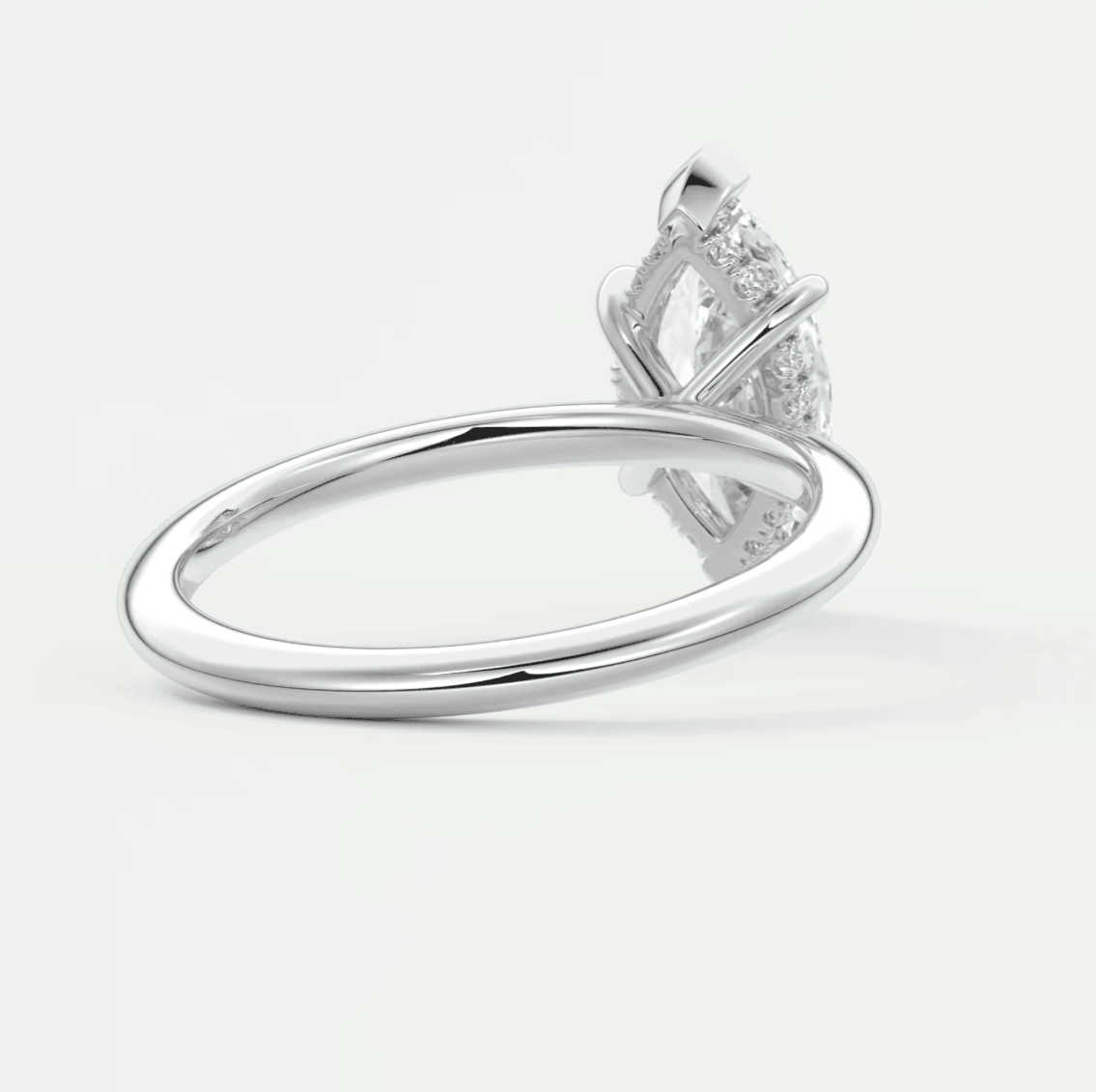 White gold diamond engagement ring with a marquise-cut center stone and small diamonds set in the band.