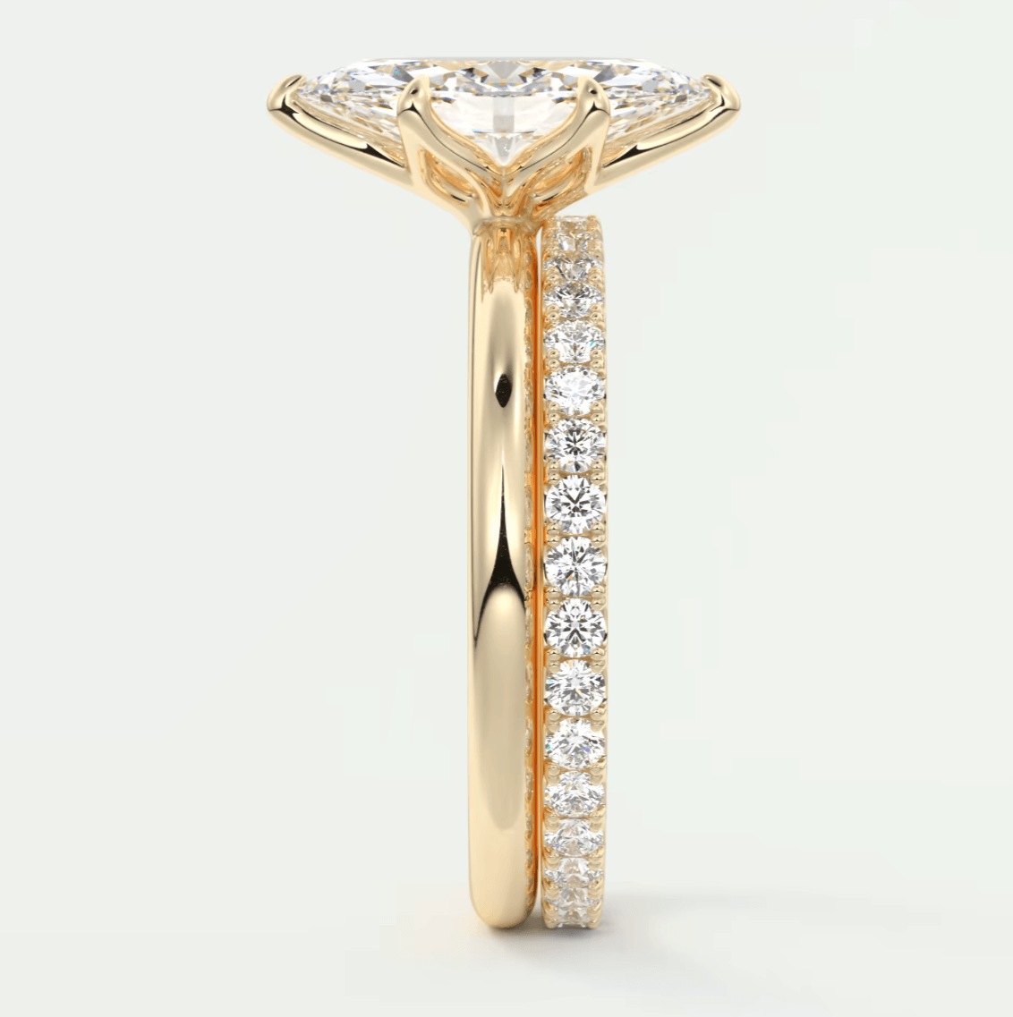 18-karat yellow gold engagement ring with a princess-cut diamond center stone and pavé set diamonds on the band.