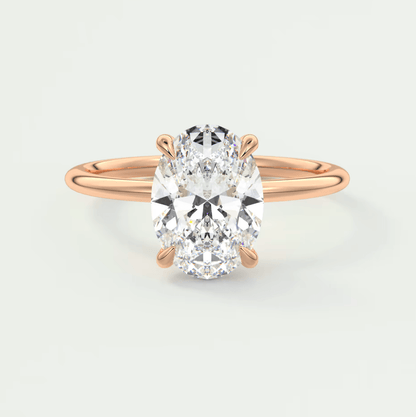 18-karat rose gold engagement ring with an oval diamond.