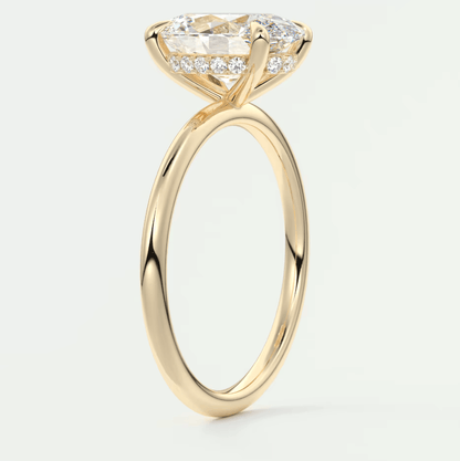 18k yellow gold engagement ring with a marquise-cut diamond and pave set side stones.