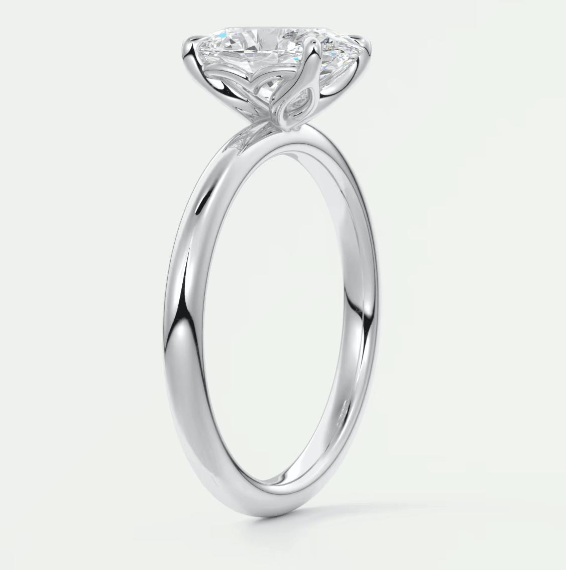 18-karat white gold solitaire diamond engagement ring with a cushion-cut center stone.