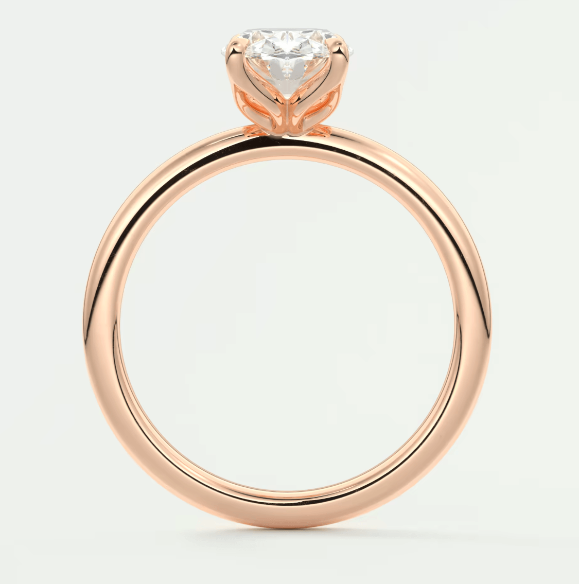 18-karat rose gold engagement ring with a round diamond.