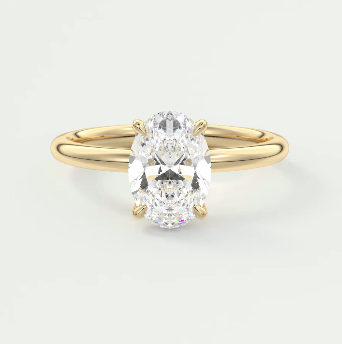 18k yellow gold oval diamond engagement ring with a solitaire setting.